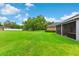 Spacious backyard with a lush, green lawn and mature trees, offering plenty of room at 1035 Stoney Creek Dr, Lakeland, FL 33811