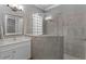 Modern bathroom featuring a large shower with glass block window and dual vanity with granite countertop at 1035 Stoney Creek Dr, Lakeland, FL 33811