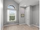 Bedroom boasts a vaulted ceiling, an arched window and neutral tones offering a serene living space at 1035 Stoney Creek Dr, Lakeland, FL 33811