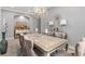 Sophisticated dining room with a large glass table, plush seating, designer lighting, and stylish decor at 1035 Stoney Creek Dr, Lakeland, FL 33811