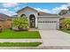 Lovely single-Gathering home boasting a manicured lawn, lush landscaping, and an attached two-car garage at 1035 Stoney Creek Dr, Lakeland, FL 33811
