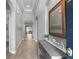 A bright and airy foyer with tray ceiling, hardwood floors, arched doorways, and a decorative console table at 1035 Stoney Creek Dr, Lakeland, FL 33811