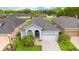 Charming home featuring a well-maintained front yard, mature landscaping, and a two-car garage at 1035 Stoney Creek Dr, Lakeland, FL 33811