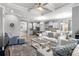 Open concept living room with tray ceiling, modern furnishings, and an adjacent kitchen and dining area at 1035 Stoney Creek Dr, Lakeland, FL 33811