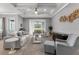 Sun-filled living room featuring a tray ceiling, neutral color palette, and lots of comfortable seating at 1035 Stoney Creek Dr, Lakeland, FL 33811