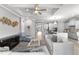 Bright, open-concept living room featuring modern furnishings and decor, flowing seamlessly into a kitchen space at 1035 Stoney Creek Dr, Lakeland, FL 33811