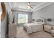 Serene main bedroom featuring a tray ceiling, plush bedding, and ample natural light at 1035 Stoney Creek Dr, Lakeland, FL 33811