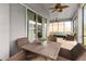 Inviting screened patio with ceiling fans and wicker furniture at 1035 Stoney Creek Dr, Lakeland, FL 33811