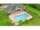 Aerial view of a community pool with lounge chairs and tropical palm trees, perfect for relaxation at 1035 Stoney Creek Dr, Lakeland, FL 33811