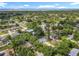 Aerial view of a cozy home near a lake surrounded by lush greenery at 1089 Algoma St, Deltona, FL 32725
