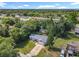 An aerial view shows the home and driveway surrounded by mature trees and landscaping at 1089 Algoma St, Deltona, FL 32725
