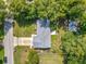 An aerial view shows the home, driveway, and surrounding tree coverage at 1089 Algoma St, Deltona, FL 32725