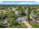 Beautiful aerial view of a home surrounded by mature trees, with ample parking and scenic neighborhood at 1089 Algoma St, Deltona, FL 32725