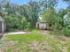 Spacious backyard featuring a shed, patio area, mature trees and established green grass at 1089 Algoma St, Deltona, FL 32725