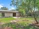 Expansive backyard featuring a patio, mature landscaping, a privacy fence and healthy green grass at 1089 Algoma St, Deltona, FL 32725