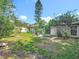 Large, established backyard with healthy green grass, a patio, and mature trees at 1089 Algoma St, Deltona, FL 32725