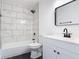 Modern bathroom features updated tile, a new sink, and shower with tub at 1089 Algoma St, Deltona, FL 32725