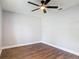 This bedroom boasts hard wood flooring and a bright ceiling fan fixture at 1089 Algoma St, Deltona, FL 32725