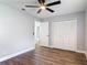 This bedroom features hard wood flooring, a ceiling fan, and a spacious closet at 1089 Algoma St, Deltona, FL 32725