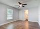 Cozy bedroom featuring wood-look floors, closet, and bathroom access at 1089 Algoma St, Deltona, FL 32725