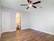Comfortable bedroom with wood-look floors and ensuite bathroom access at 1089 Algoma St, Deltona, FL 32725