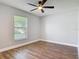 This bedroom boasts hard wood flooring and a ceiling fan fixture at 1089 Algoma St, Deltona, FL 32725