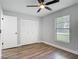 This bedroom features wood flooring, closet space, a ceiling fan, and window at 1089 Algoma St, Deltona, FL 32725