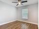 This bedroom boasts hard wood flooring, natural light, and a modern ceiling fan at 1089 Algoma St, Deltona, FL 32725