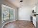 Bright dining area featuring hardwood floors, a large window, and modern pendant lighting at 1089 Algoma St, Deltona, FL 32725