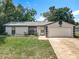Charming single-story home with a well-maintained lawn and attached one car garage at 1089 Algoma St, Deltona, FL 32725