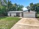 Inviting single-story home boasts an attached garage and well-kept lawn at 1089 Algoma St, Deltona, FL 32725