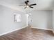 Bright living room boasts wood-look floors and a modern ceiling fan for year-round comfort at 1089 Algoma St, Deltona, FL 32725