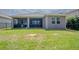 Spacious backyard with a covered patio, perfect for outdoor relaxation and entertainment at 13940 Magnolia Ridge Loop, Winter Garden, FL 34787