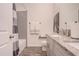 Bright bathroom featuring a shower and tub combo with gray subway tile surround and a gray vanity at 13940 Magnolia Ridge Loop, Winter Garden, FL 34787