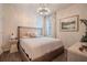Cozy bedroom featuring modern decor, wood-look tile flooring, and soft lighting at 13940 Magnolia Ridge Loop, Winter Garden, FL 34787