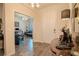 Inviting foyer with wood-look tile flooring, elegant lighting, and open view to the office at 13940 Magnolia Ridge Loop, Winter Garden, FL 34787