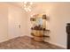 Foyer with wood-look tile flooring, stylish light fixture, and decorative console table at 13940 Magnolia Ridge Loop, Winter Garden, FL 34787