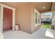 Covered front porch with a charming entryway and neutral color scheme at 13940 Magnolia Ridge Loop, Winter Garden, FL 34787