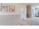 Neutral hallway showing community bulletin boards and an access door, set on a patterned brick walkway at 13940 Magnolia Ridge Loop, Winter Garden, FL 34787