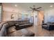 Open concept living room featuring a large leather sofa and a modern ceiling fan at 13940 Magnolia Ridge Loop, Winter Garden, FL 34787