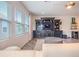 Comfortable living room featuring a large entertainment center and natural light at 13940 Magnolia Ridge Loop, Winter Garden, FL 34787