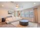 Bright living area with a modern sofa, large windows, and neutral decor at 13940 Magnolia Ridge Loop, Winter Garden, FL 34787