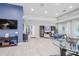 Inviting resident lounge with comfortable seating, a large TV, and stylish decor at 13940 Magnolia Ridge Loop, Winter Garden, FL 34787