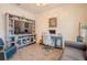 Well-lit office space with wood-look tile flooring, comfortable seating, and a stylish desk at 13940 Magnolia Ridge Loop, Winter Garden, FL 34787