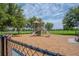 Community playground with slides, climbing structures, and a secure fenced perimeter at 13940 Magnolia Ridge Loop, Winter Garden, FL 34787