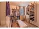 Spacious walk-in closet with custom shelving and hanging racks, plus a comfortable bench at 13940 Magnolia Ridge Loop, Winter Garden, FL 34787