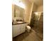 Bathroom features a single sink vanity, granite counters, and a shower at 14117 Larkspur Lake Dr, Winter Garden, FL 34787