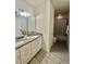 Bathroom showcasing a double vanity with granite countertops and tile flooring at 14117 Larkspur Lake Dr, Winter Garden, FL 34787