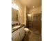Bathroom features a single sink vanity, granite counters, and a shower at 14117 Larkspur Lake Dr, Winter Garden, FL 34787