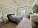 This bedroom features a brick accent wall, ceiling fan, and natural light from the window at 14117 Larkspur Lake Dr, Winter Garden, FL 34787